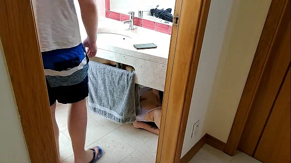 Stepsister receives facial cumshot through a hole in the sink