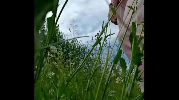 Naked horny MILF in a chamomile field masturbates, pisses and wards off a wasp / Angela-MILF